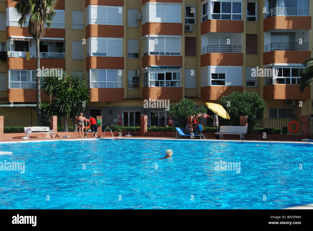 Apartment block with swimming pool in foreground, Lagos, Algarrobo Costa, Costa del Sol, Malaga Province, Andalucia, Spain. Stock Photo