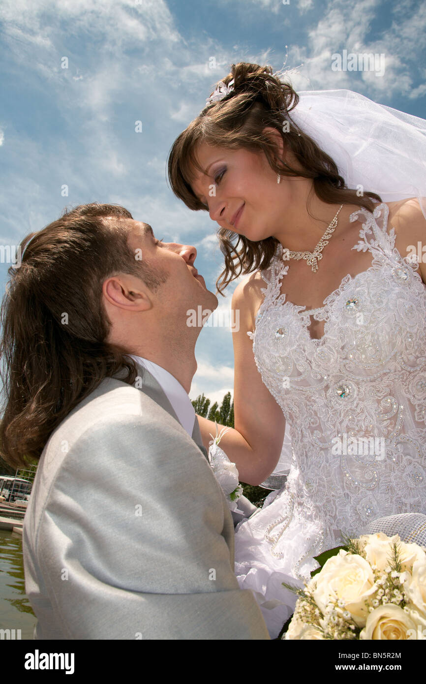 Groom and the bride embrace on a background of the dark blue sky Stock ...