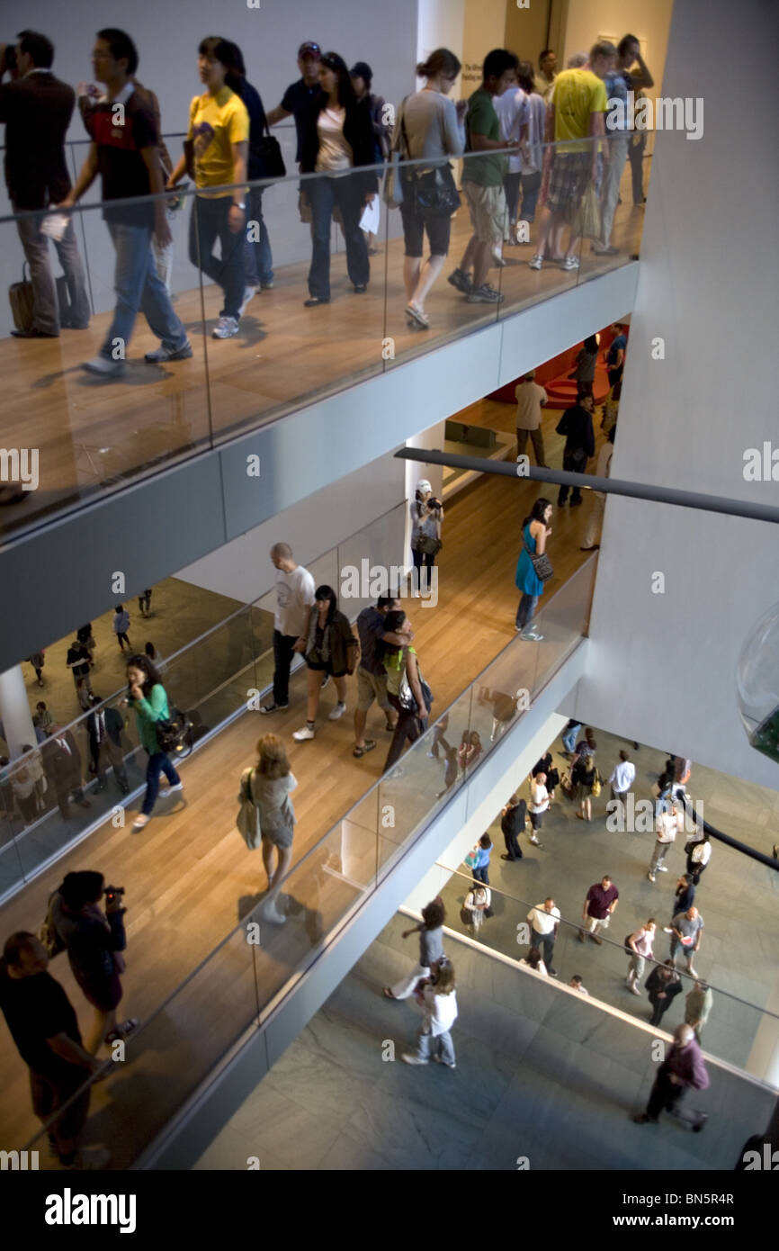 Crowds become part of the interior architecture at the Museum of Modern Art in New York City. Stock Photo