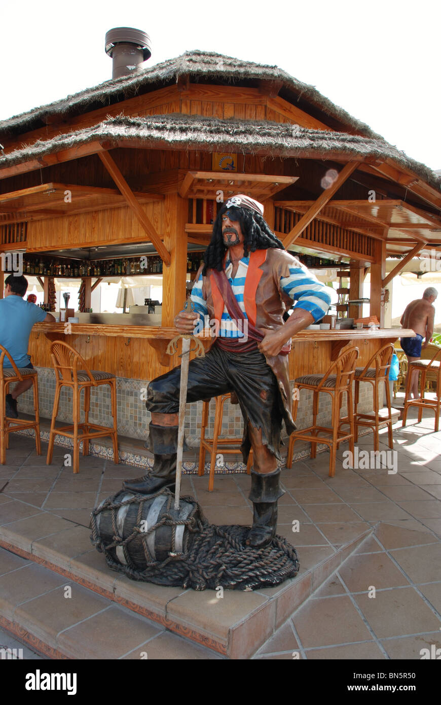 Beach bar (chiringuito) with a pirate statue in the foreground, Torremolinos, Costa del Sol, Malaga Province, Andalucia, Spain. Stock Photo