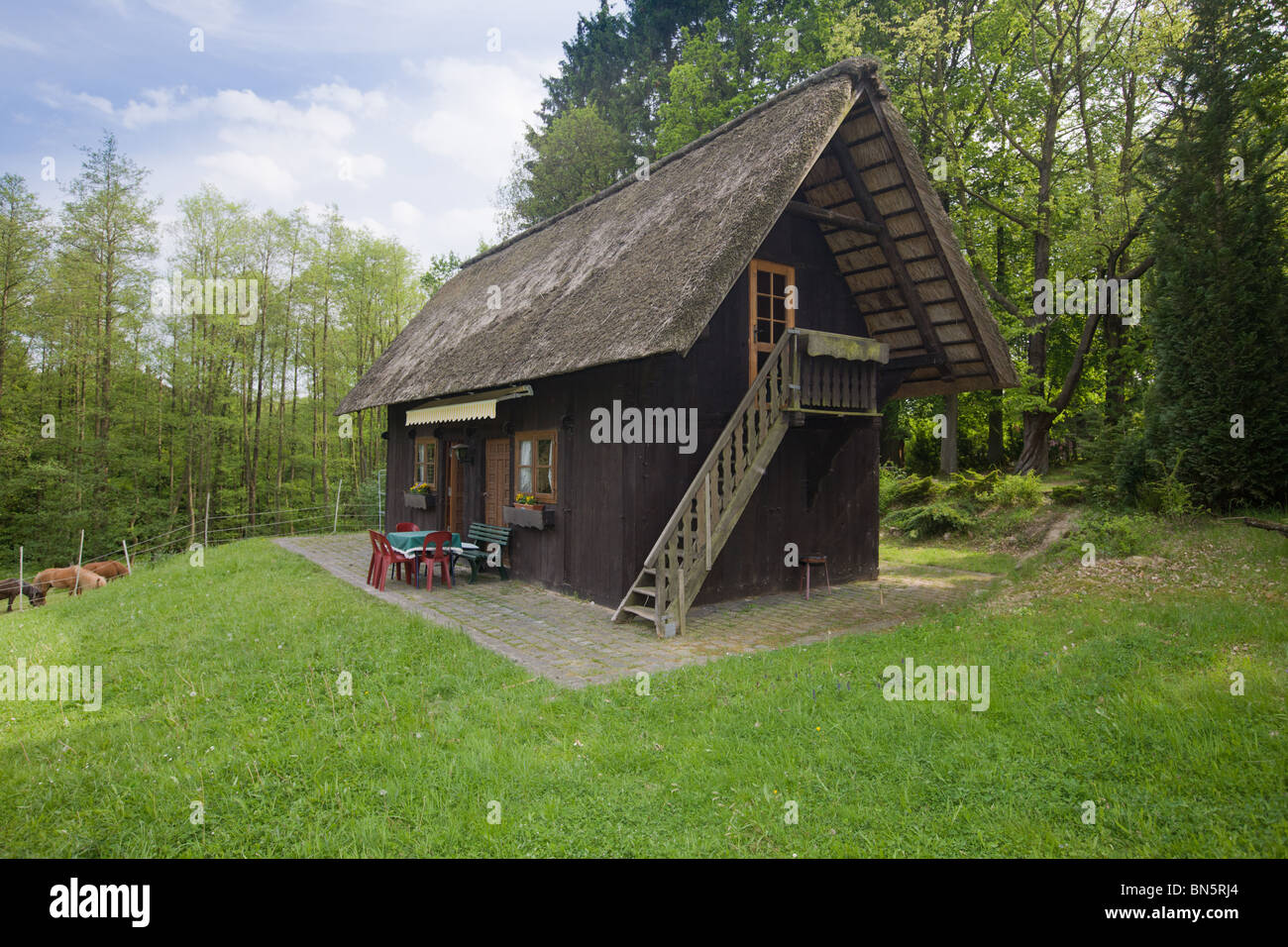 Thatched roof cottage used as a holiday home on a farm Stock Photo