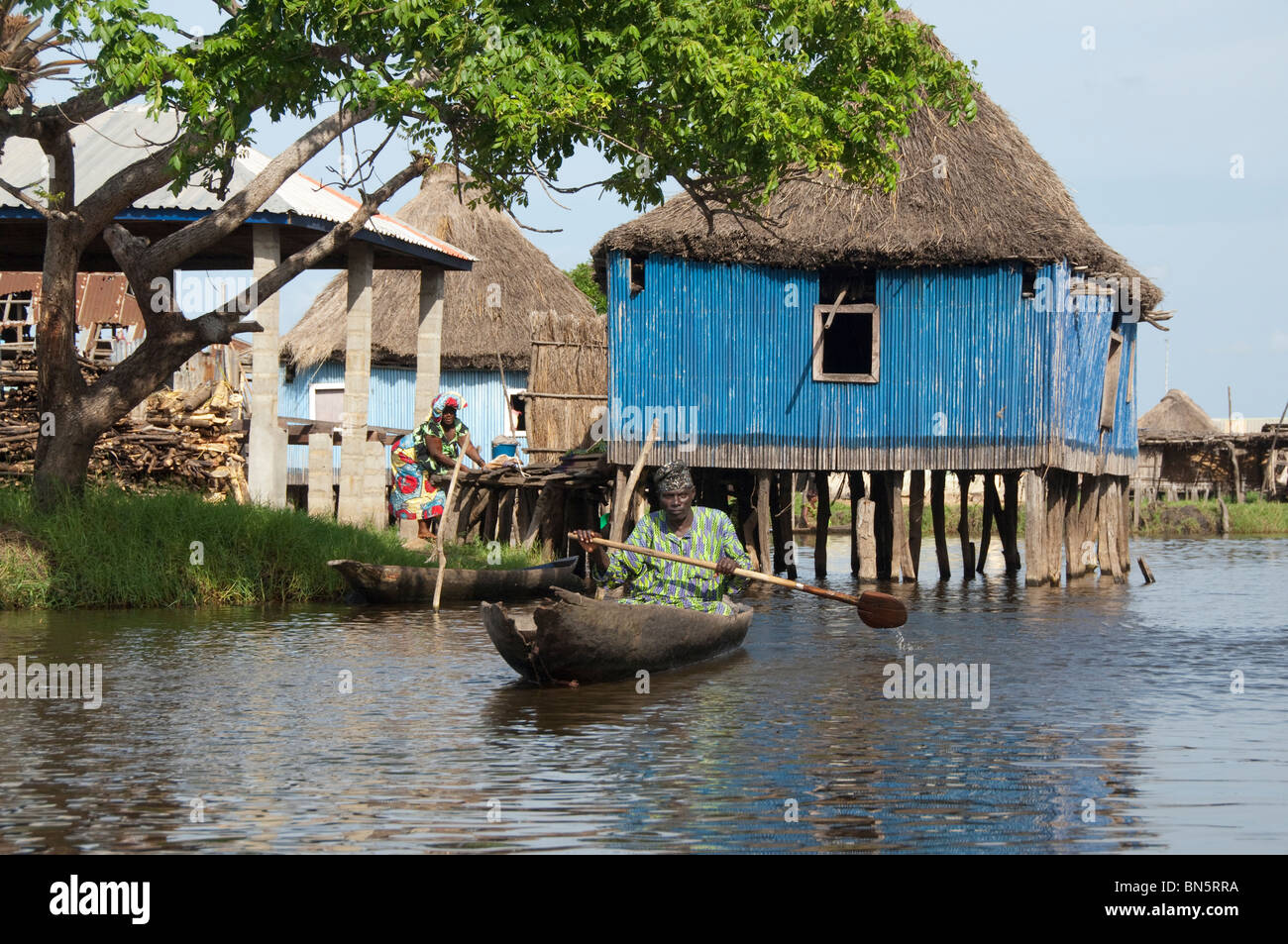 Africa, Benin, Ganvie. Tofinu villager in dugout canoe on the waters of Lake Nokoue. Stock Photo