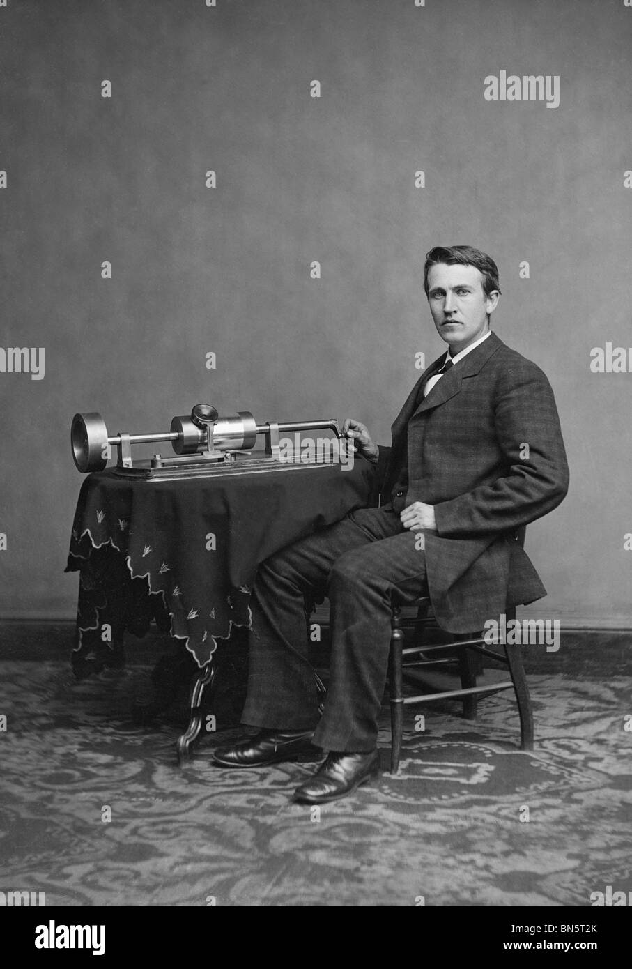 Portrait photo c1877 of American inventor, scientist and businessman Thomas Edison (1847 - 1931) and his cylinder phonograph. Stock Photo
