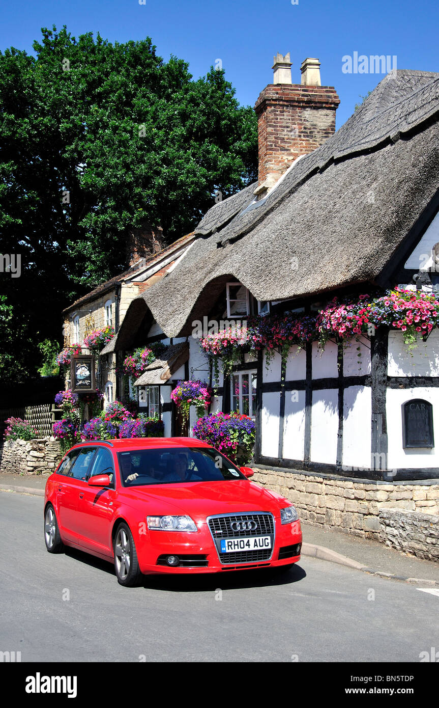 Car driving past The Fox & Hounds Inn, Church Street, Bredon