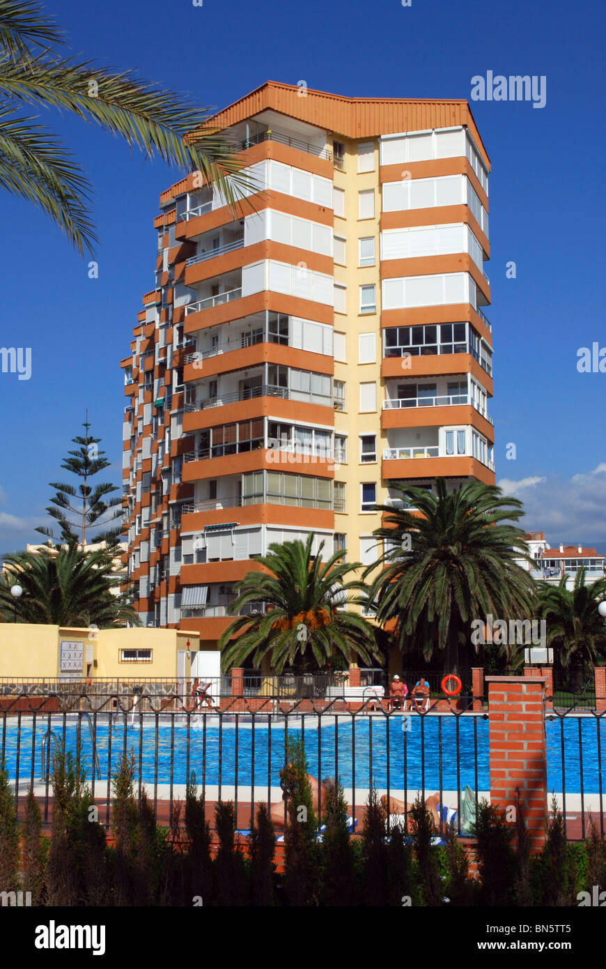 Apartment block with swimming pool in foreground, Lagos, Algarrobo Costa, Costa del Sol, Malaga Province, Andalucia, Spain. Stock Photo