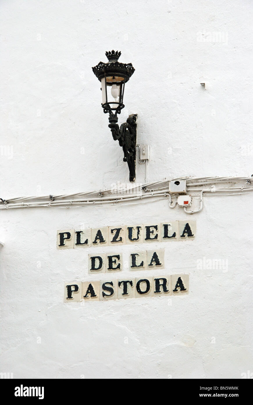 Arco de la Pastora sign and lantern, Medina Sidonia, Cadiz Province, Andalucia, Spain, Western Europe. Stock Photo