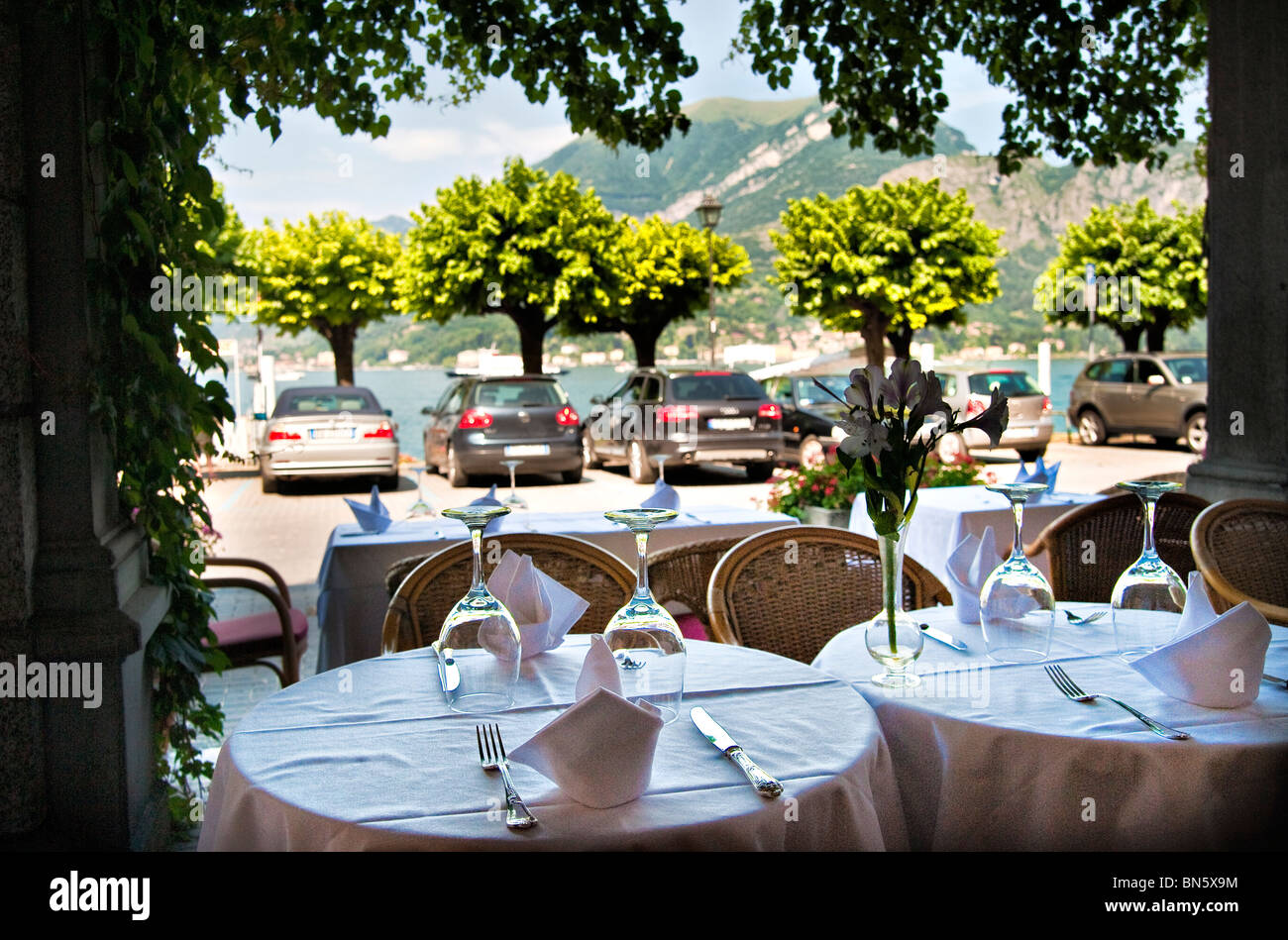 Tables set ina restaurant on the lake front, Bellagio, Italy Stock Photo
