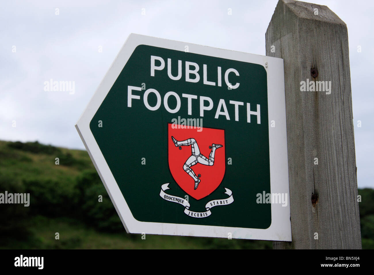 Manx public footpath sign, showing the Three Legs of Man symbol, in the Isle of Man. Stock Photo