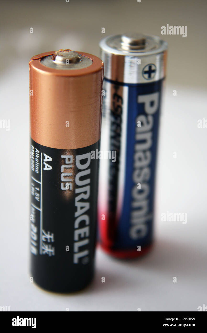 A Duracell Plus AA battery and a Panasonic AA battery product image. Stock Photo