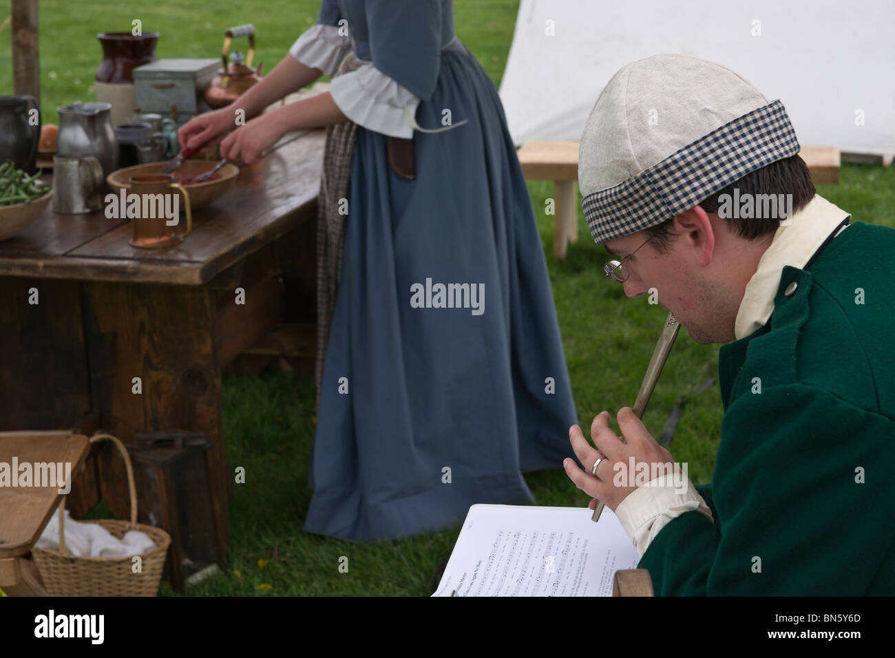 Tulip time festival Dutch Holland Michigan in USA   A Dutch woman preparing a meal and a man musician dressed in traditional costume hi-res Stock Photo