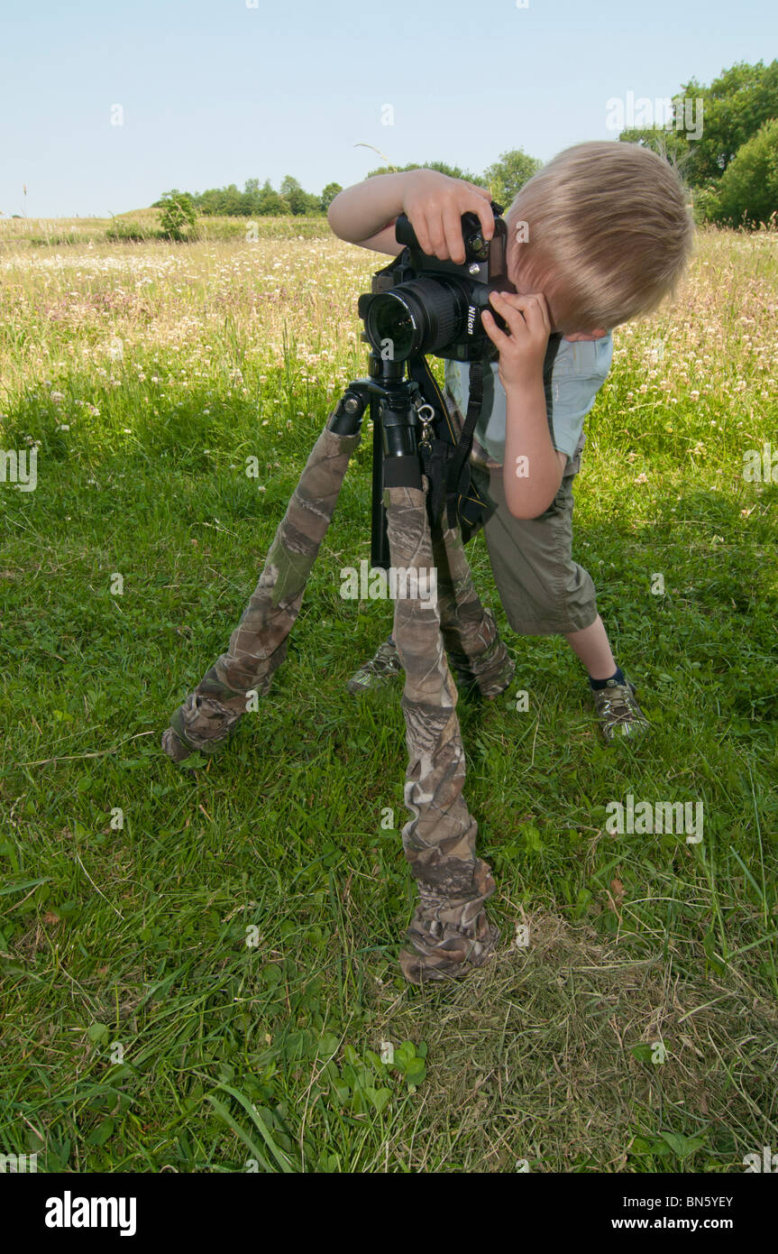 Young boy taking pictures with camera Stock Photo - Alamy