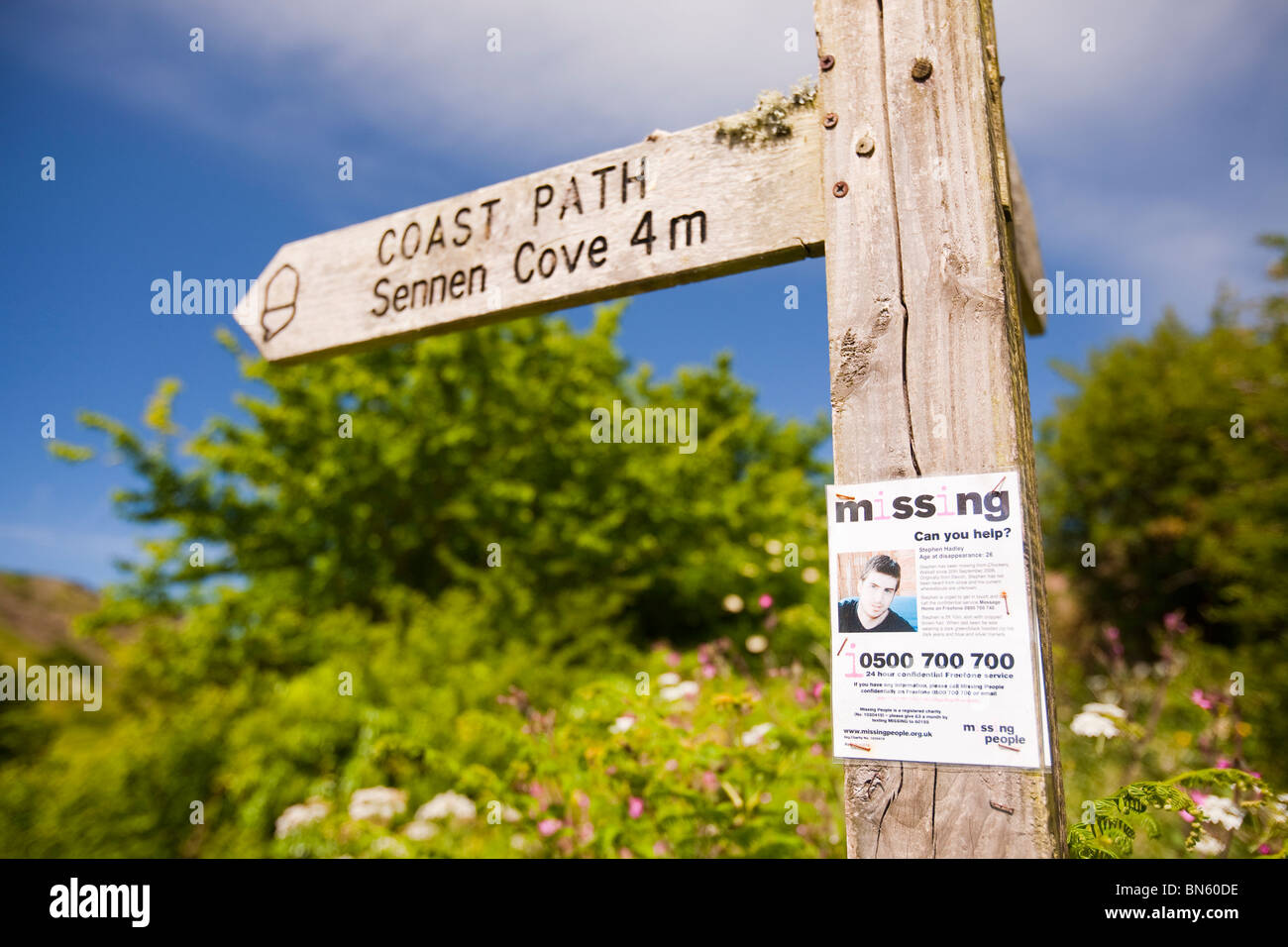 A poster about a missing person on a footpath sign post in St Just, Cornwall, UK. Stock Photo
