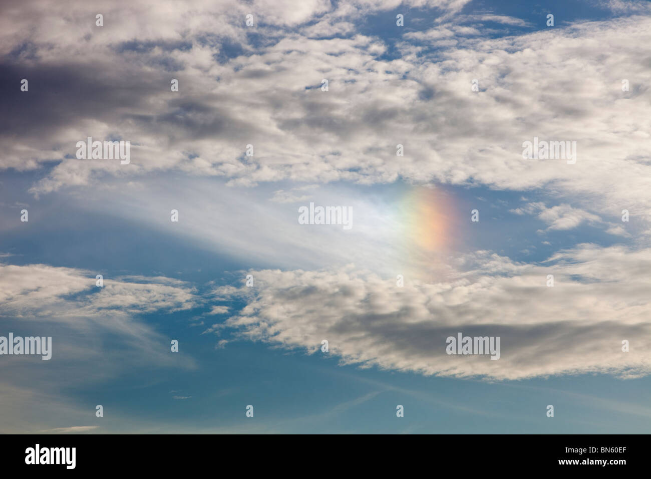 Sun dogs or Parhelion in high level clouds above Ambleside, UK, caused by light refracting off ice crystals. Stock Photo