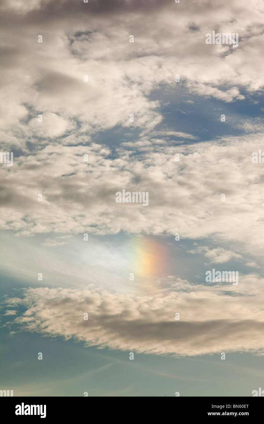 Sun dogs or Parhelion in high level clouds above Ambleside, UK, caused by light refracting off ice crystals. Stock Photo