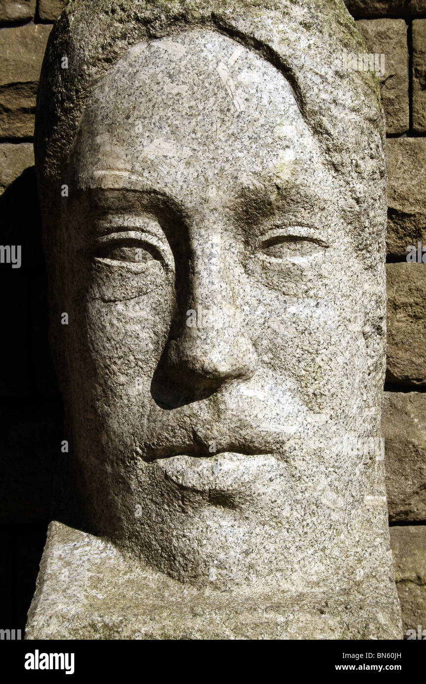 Stone Face Sculpture carved in Granite rock Stock Photo