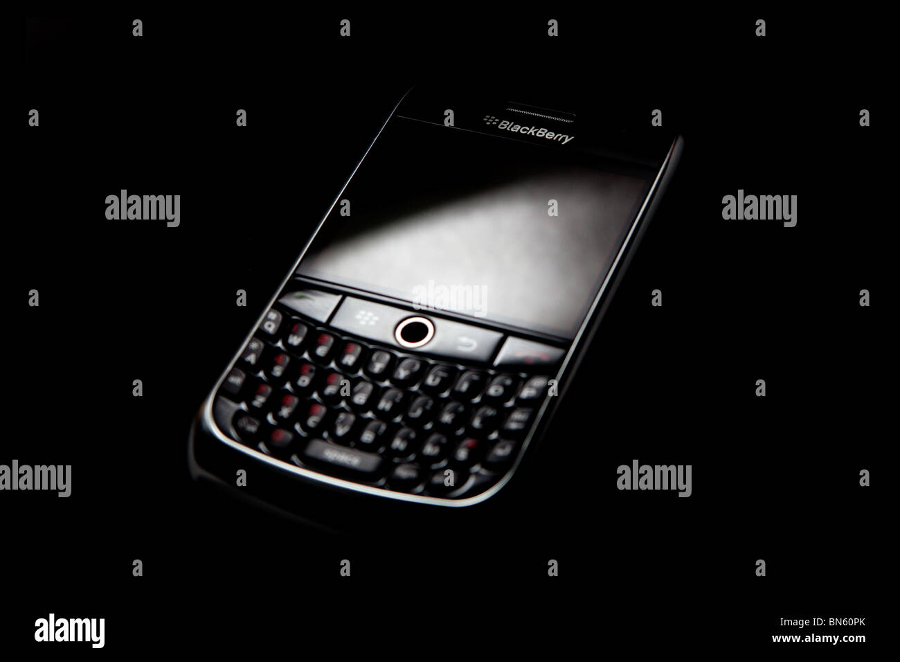 Blackberry 8900 on black background - Stock Image