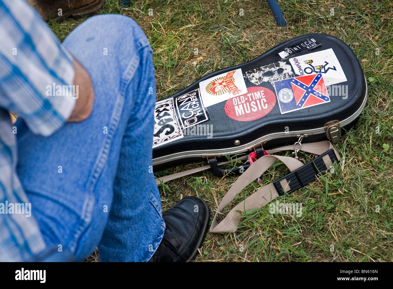 A fiddler sitting next to his violin case at the Smithville Jamboree of