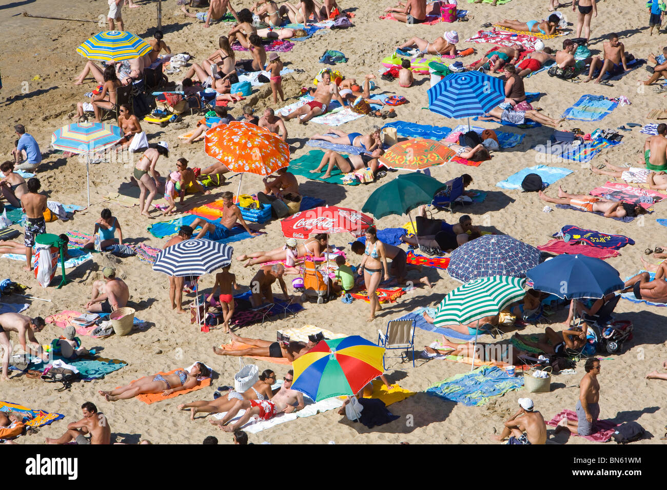 Beach scene sunbathers colorful umbrellas hi-res stock photography and