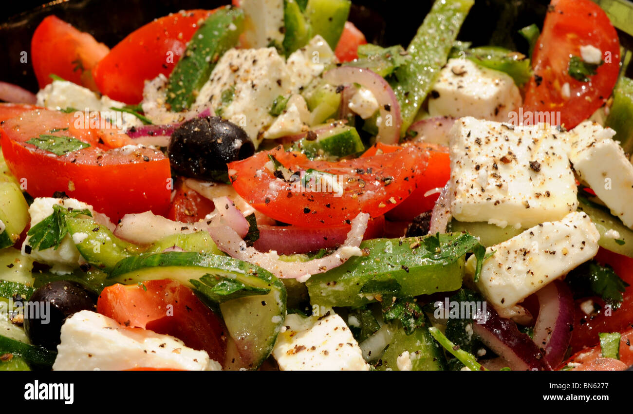 Fresh made Greek Salad with tomatoes green peppers red onion feta cheese and black olives Stock Photo