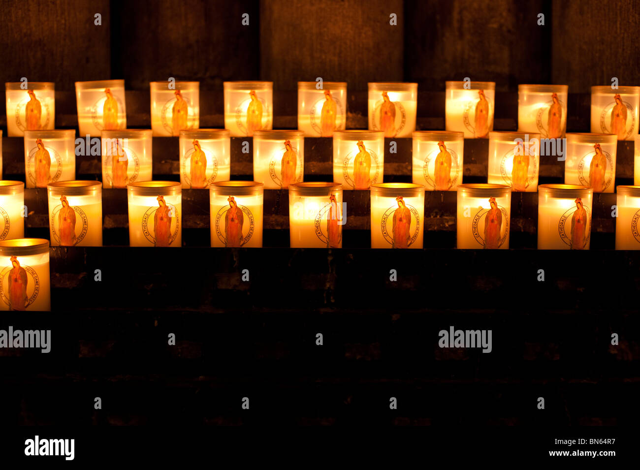 Candles lit as offerings at the Notre Dame Cathedral in Paris, France