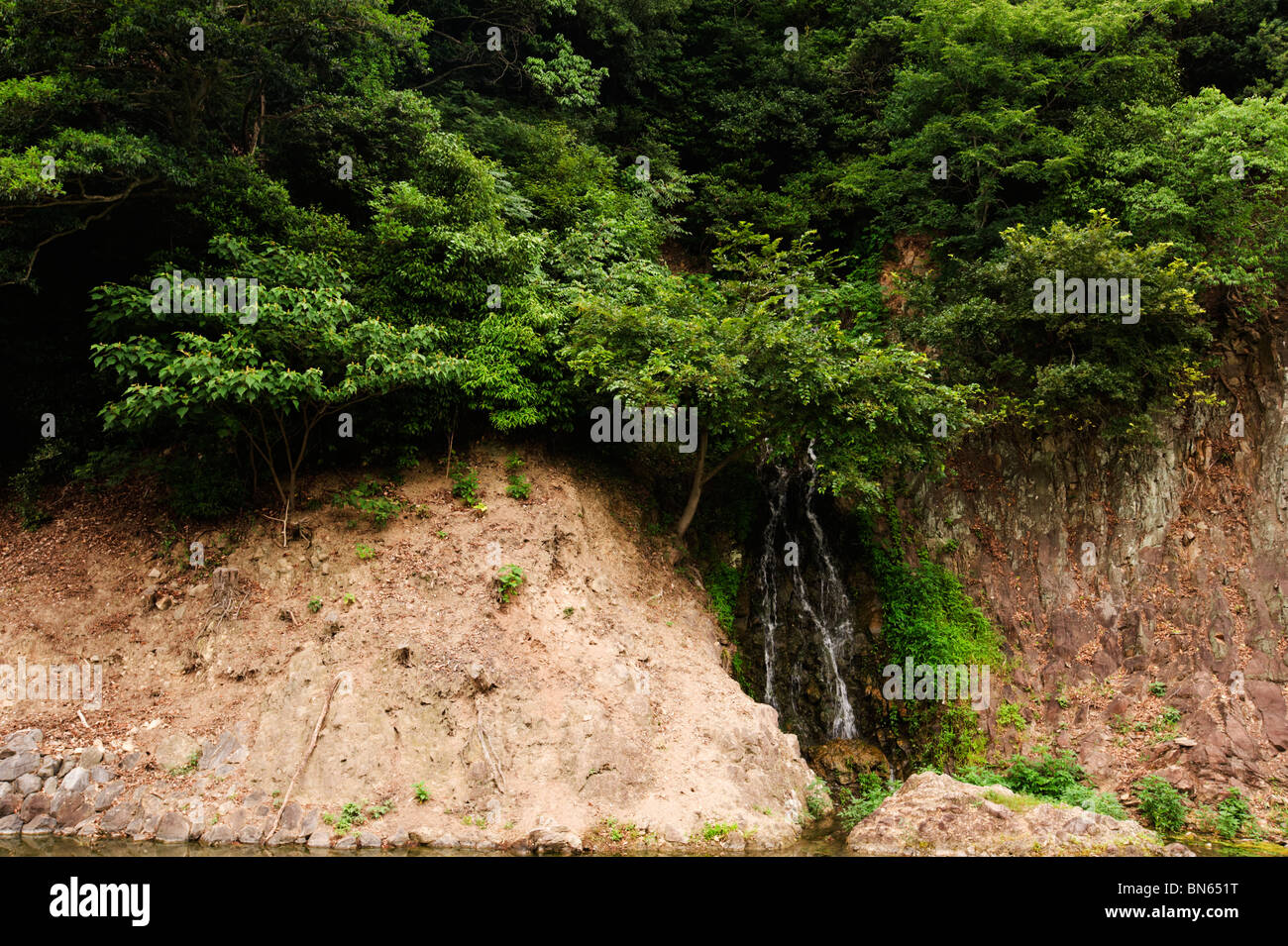 The  waterfall at Ritsurin park was once operated by barrels of water brought up the hill, now they are pumped electronically. Stock Photo