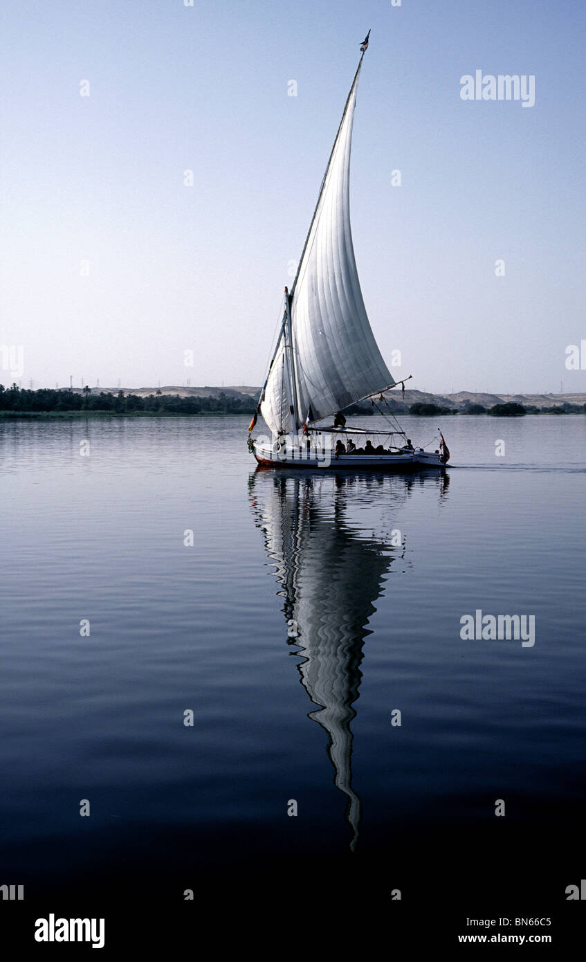 Felucca gliding across the river Nile at dusk between Aswan and Kom Ombo in Upper Egypt. Stock Photo