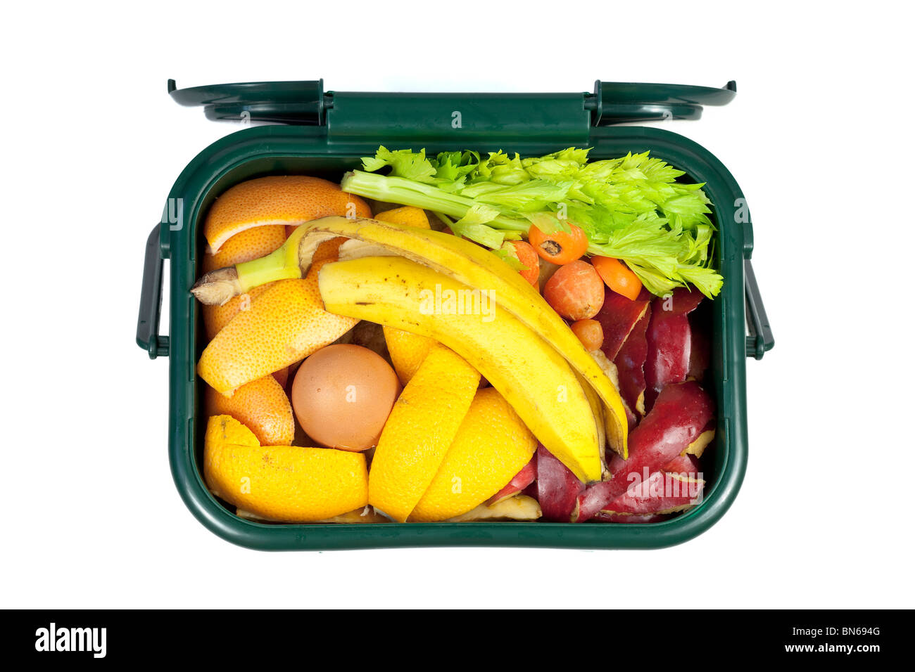 Food waste for composting in domestic recycling waste bin Stock Photo