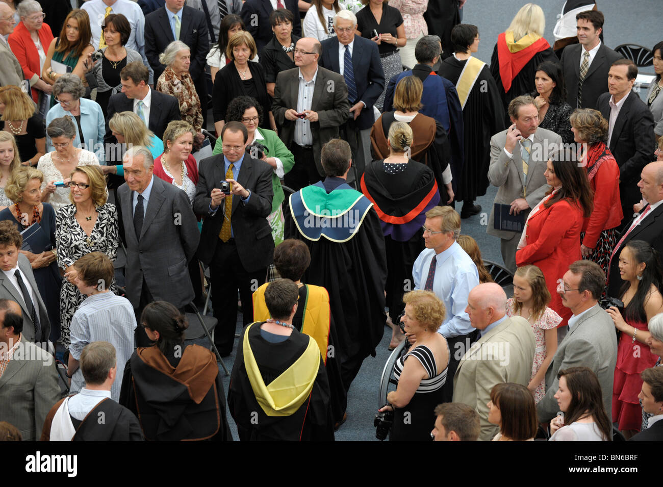 Graduates walk through the audience at a graduation ceremony Stock