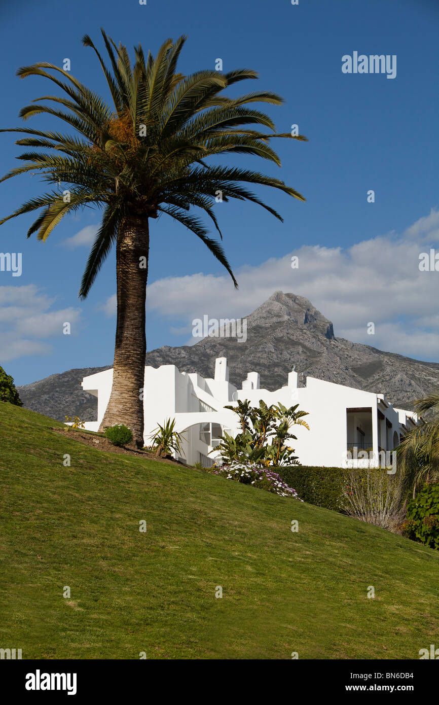 A beautiful white house on a spanish hillside, overlooked by mountains Stock Photo
