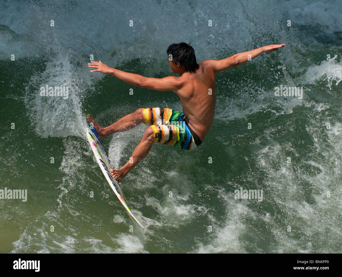 Surfer catching a wave Stock Photo Alamy