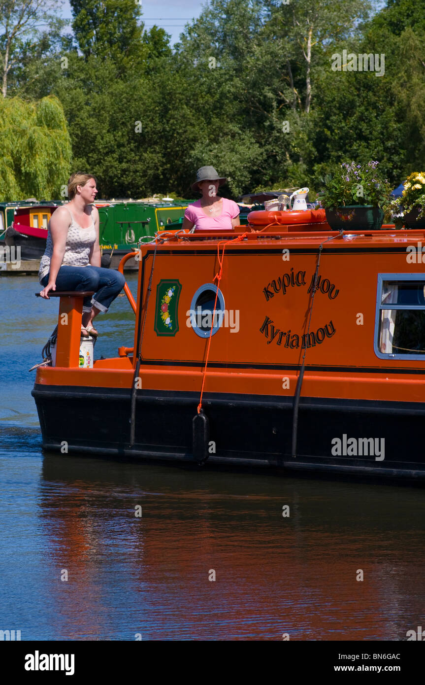 Stern Of A Narrowboat With Two Women Leaving Pyrford Marina Surrey
