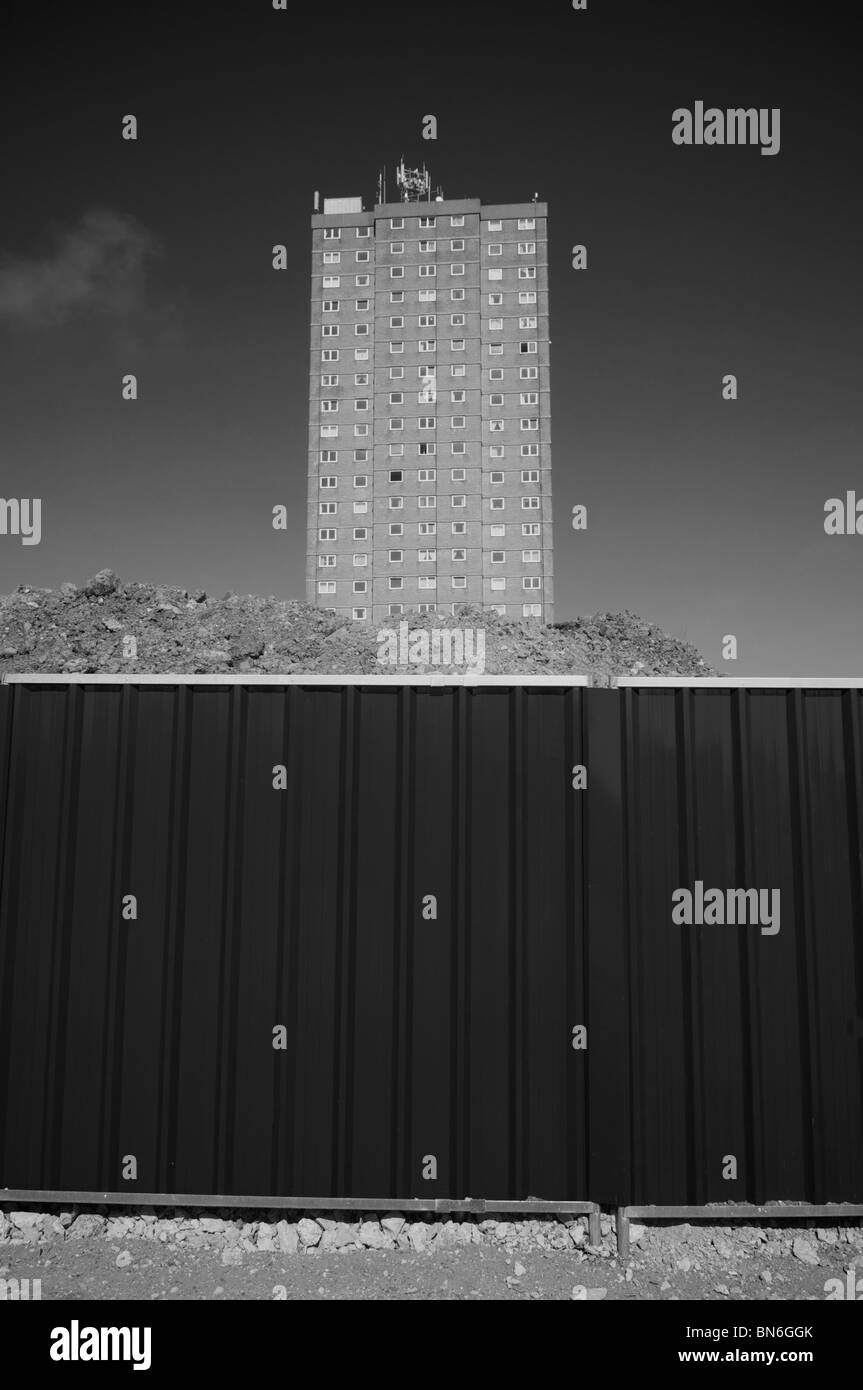High rise block of flats behind metal fence awaiting demolition Stock Photo
