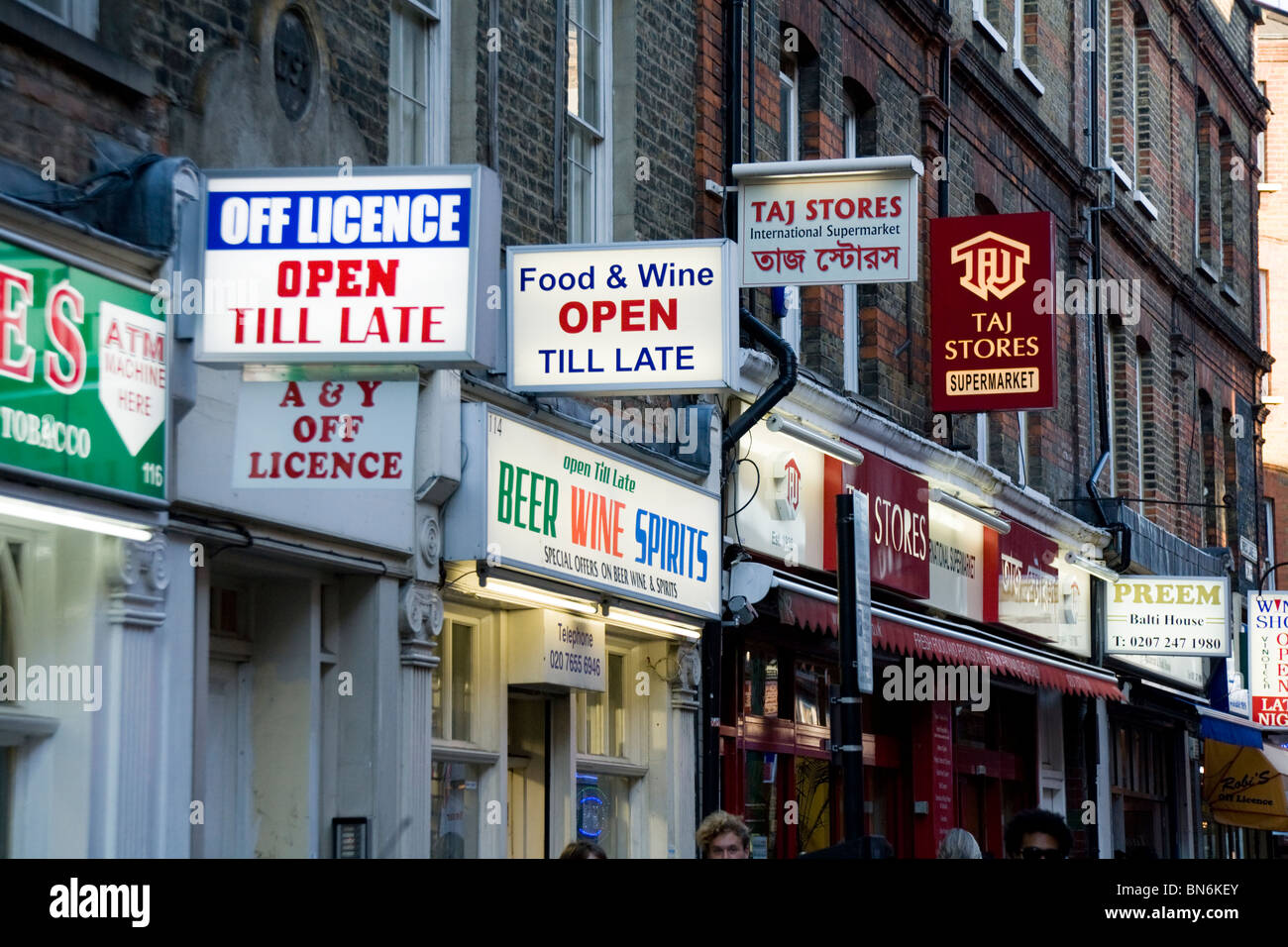 Signs above Indian / Asian stores and shops – businesses – on Brick Lane in East London. UK. Stock Photo