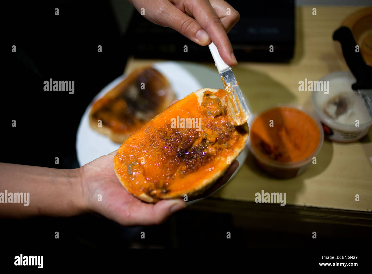 A woman spreads red pork lard, or manteca colorada, made from Spanish Iberian pigs in Andalusia
