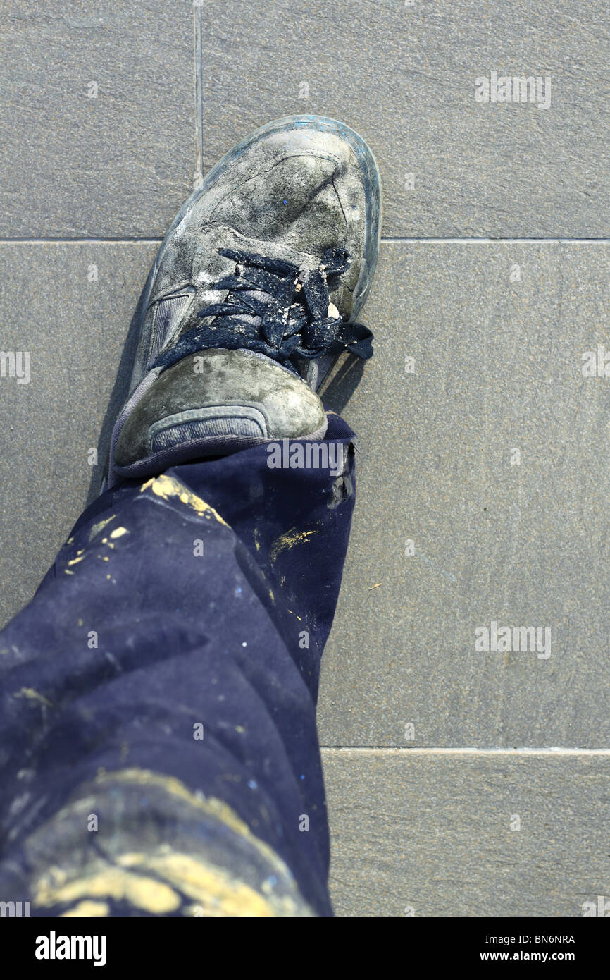 manual man worker old shoes detail high view dirty pants Stock Photo