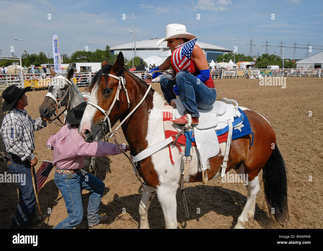 Cowgirl riding a horse at a rodeo parade Stock Photo