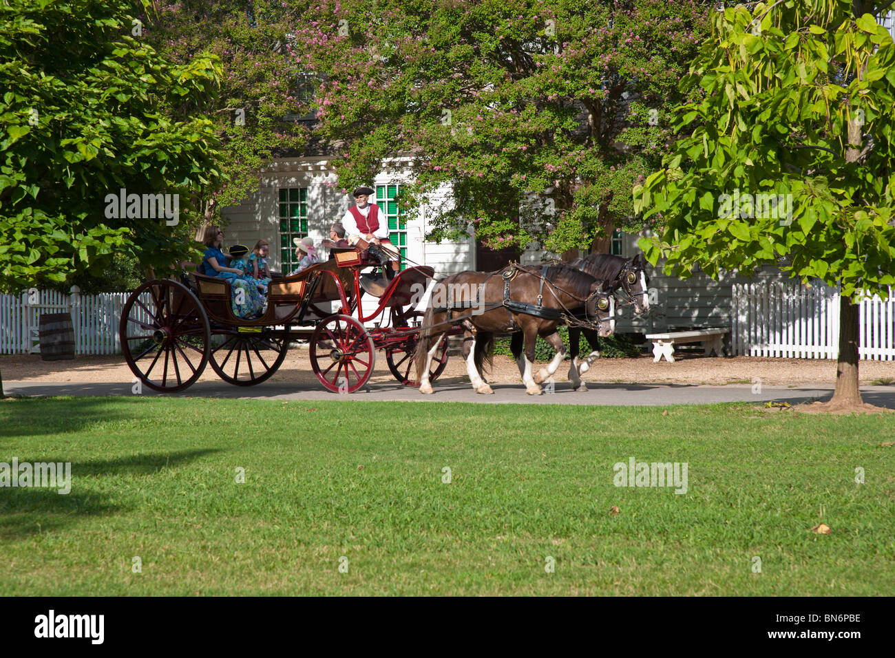 Family taking horse drawn carriage ride at Colonial Williamsburg living