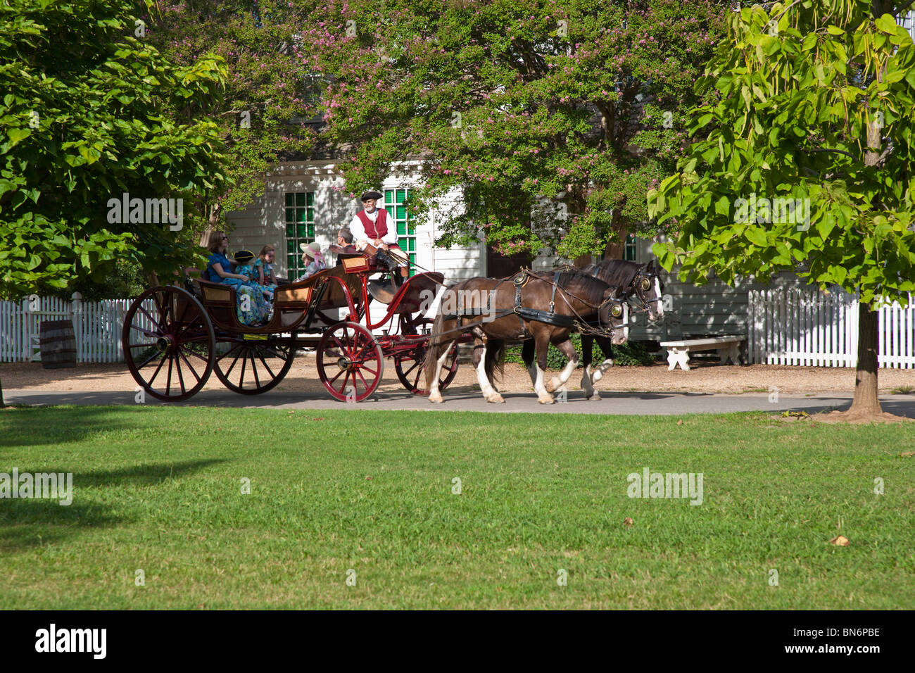 Family taking horse drawn carriage ride at Colonial Williamsburg living history museum in Williamsburg Virginia. Stock Photo