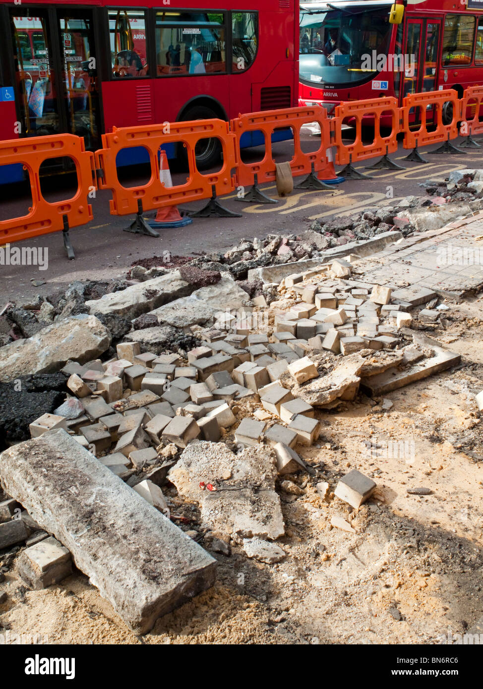 Pavement and roadworks with buses behind in Upper Street Islington north London England UK Stock Photo