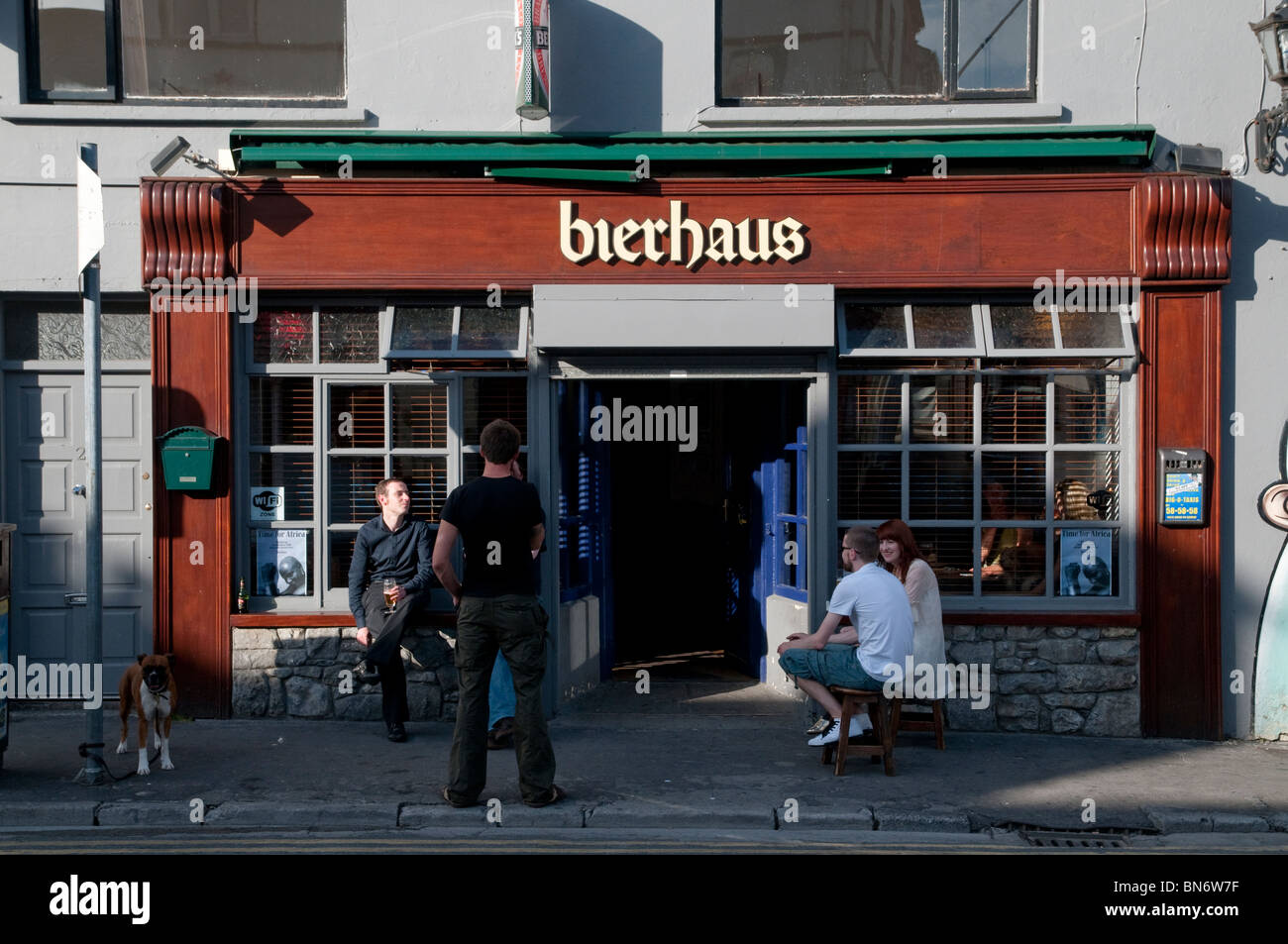 Exterior of the Bierhaus pub in Galway, Ireland with drinkers (and dog) enjoying summer evening. Stock Photo