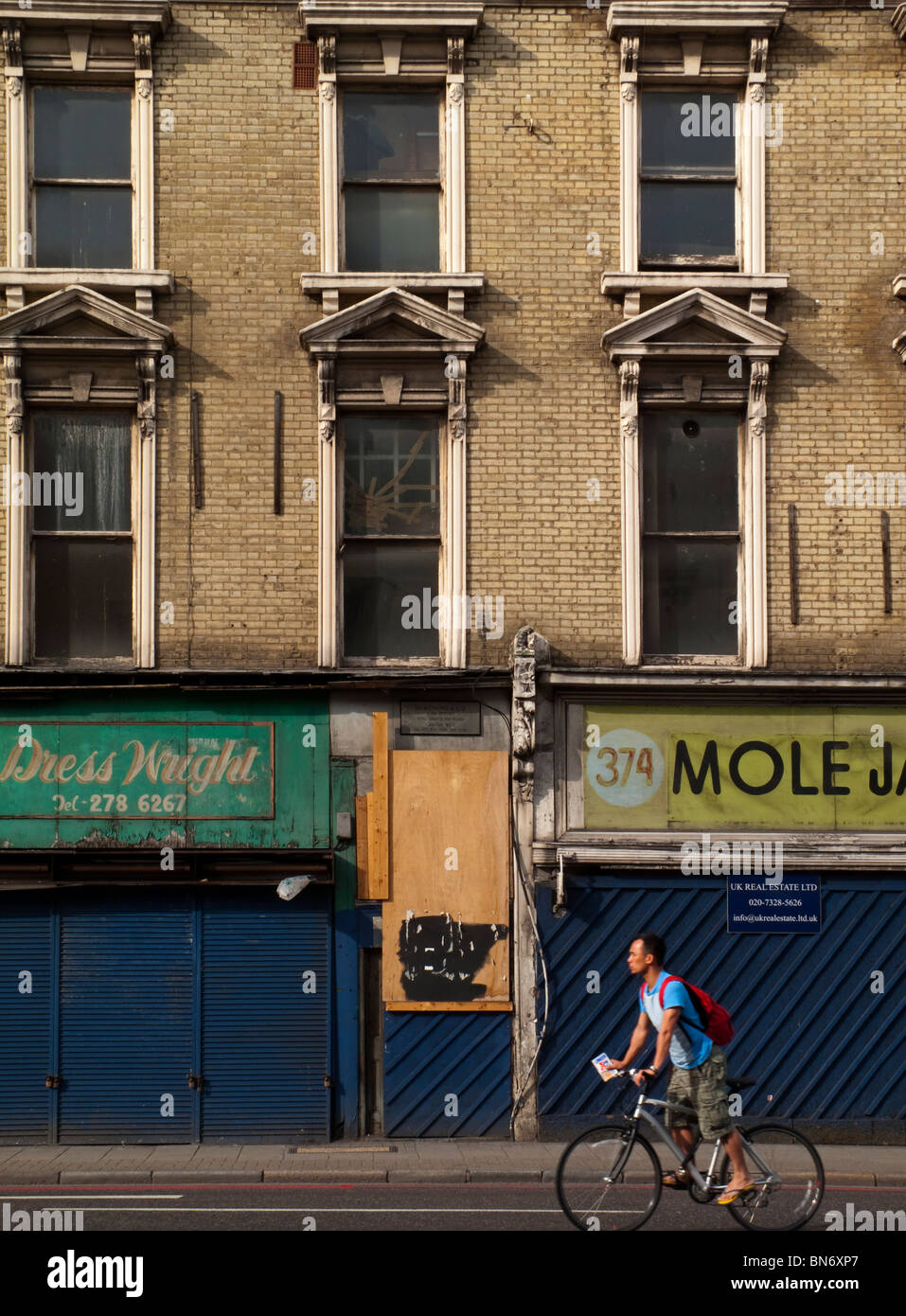 Run down and boarded up shops and offices in King's Cross north London England UK showing inner city urban decay Stock Photo