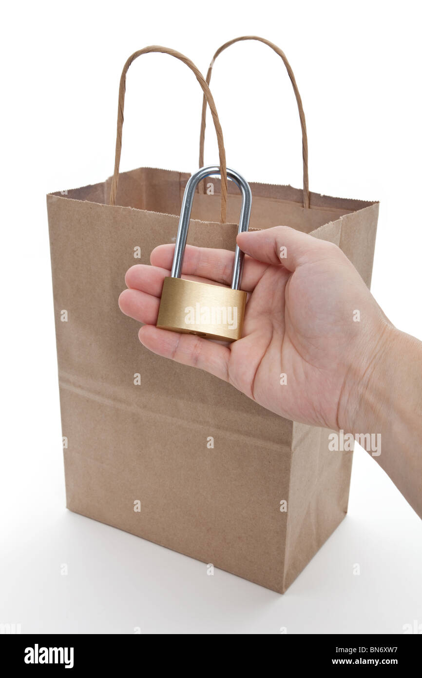 Brown paper shopping bag and lock, concept of tighten tudget Stock Photo