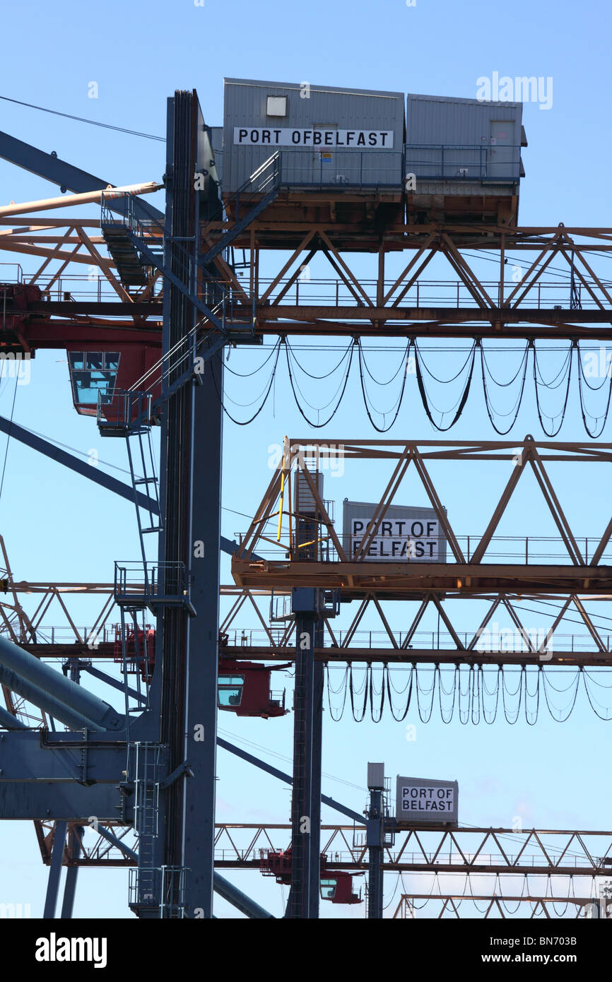 row of overhead cranes at Belfast dockside, displaying 'port of Belfast' signs Stock Photo