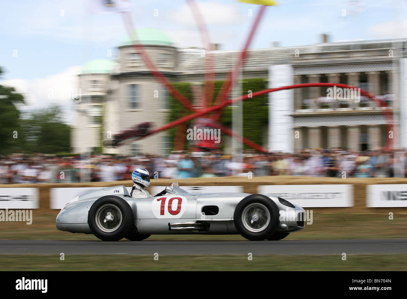Mika Hakkinen in an historic Mercedes Grand Prix F1 car powers past