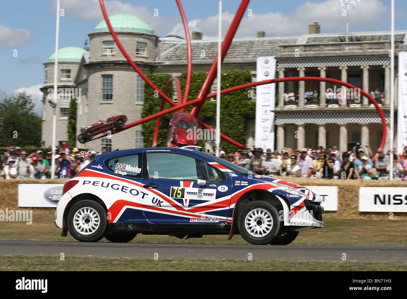Kris Meeke powers his Peugeot 207 S2000 IRC rally car up the hill at the 2010 Goodwood Festival of Speed, Goodwood House. Stock Photo