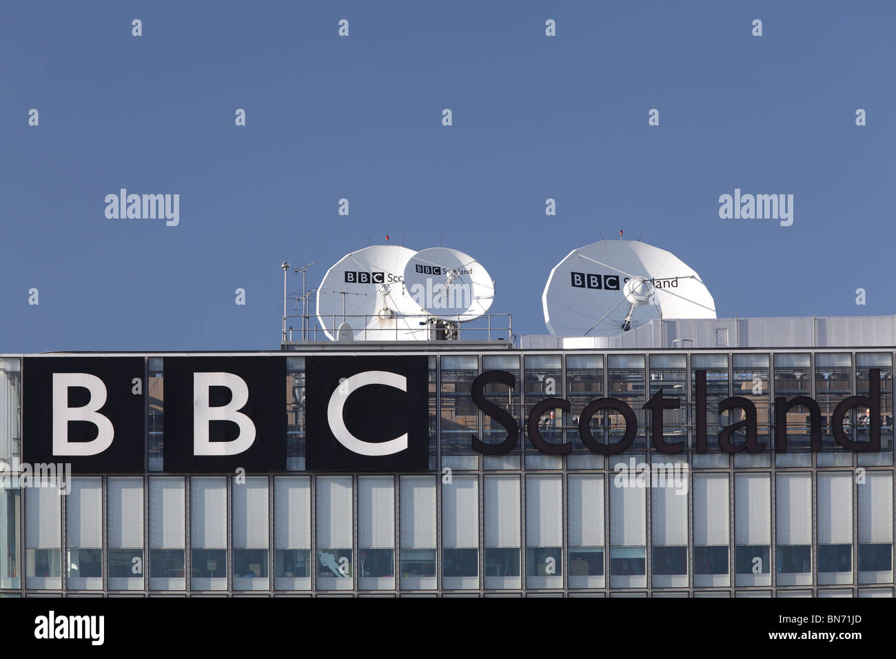 BBC Scotland sign and satellite dishes on the Pacific Quay Headquarters building in Glasgow, Scotland, UK Stock Photo