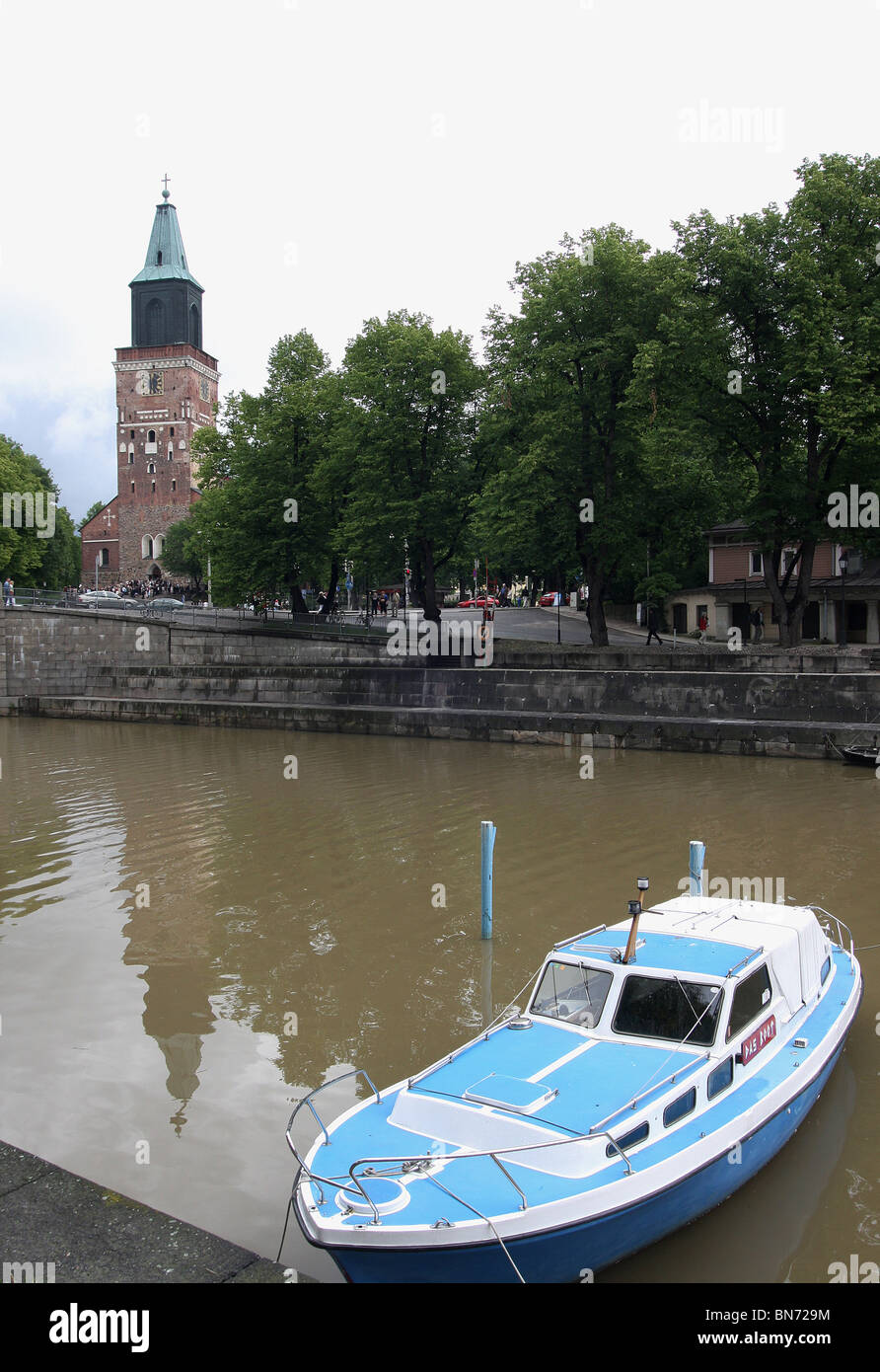 Boat on the River Aura, Turku, Finland with the Lutheran Cathedral in the background Stock Photo