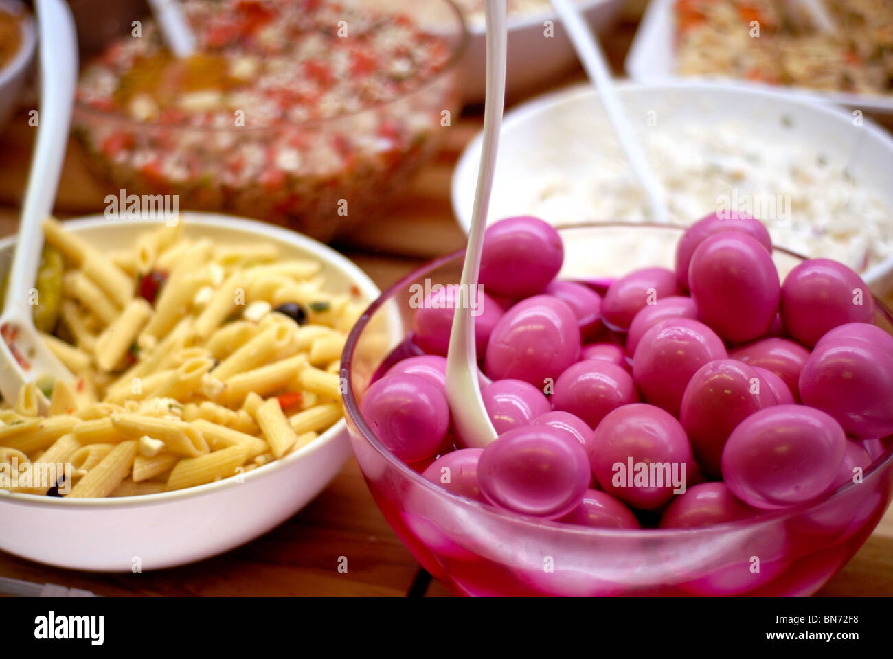 Deviled egg, salsa and pasta salad are some of the deli foods pictured. Stock Photo
