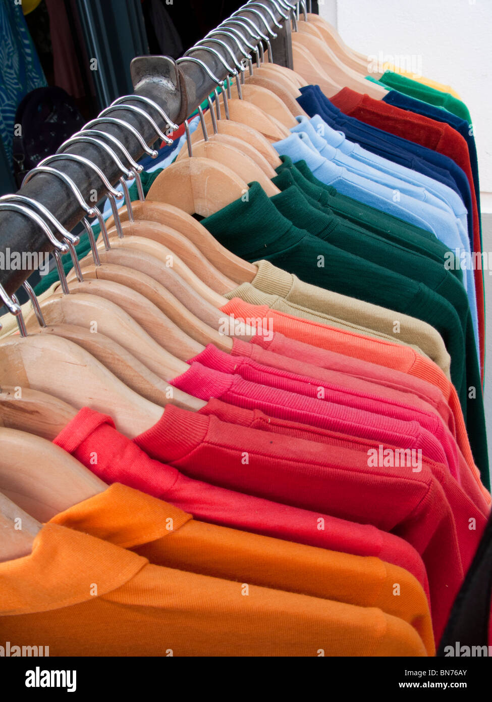 Racks of colourful shirts hanging outside fashion boutique in bohemian Friedrichshain district of Berlin Germany Stock Photo