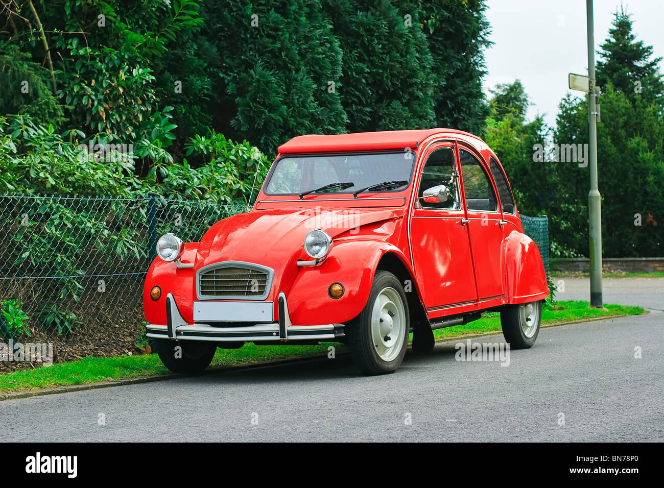 French red Citroen 2 cv parked in a street Stock Photo